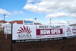 Sign announcing opening of West Tulare medical and dental clinic